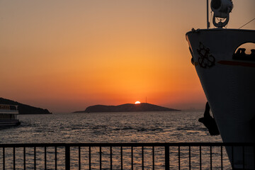 Poster - Beautiful sunset over Prince Islands with silhouette of boat and calm waters during golden hour