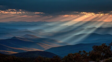 Wall Mural - the sun shines through the clouds, illuminating the mountain range in the blue mountains national pa
