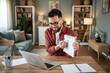 © Migma_Agency - Architect showing blueprint during online meeting from home