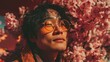 © BlackBird Studio - Stylish Young Man with Sunglasses Surrounded by Cherry Blossom Flowers in Vibrant Colors