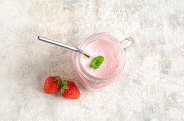 Wall Mural - Mason jar of tasty strawberry smoothie on light background