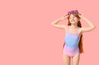 © Pixel-Shot - Little redhead girl in swimsuit on pink background