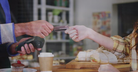 Poster - Image of financial data over hands of caucasian people using payment terminal
