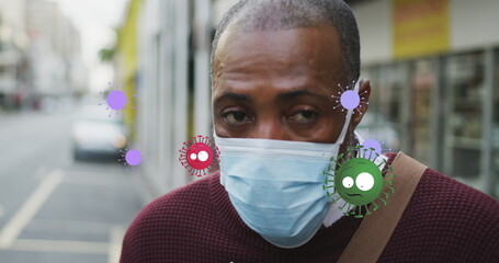 Poster - Image of falling covid 19 cells over african american men wearing face mask