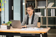 © Thitisak - Asian businesswoman using laptop, working in office