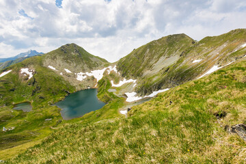 Wall Mural - alpine lake capra in mountains of romania. rippled water. outdoor adventure. travel background with 
