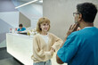 © TrueFrame Collective - Patient and Dentist Talking While Standing at Reception Desk