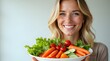 © Orislava - A smiling Caucasian woman holds a vibrant plate of fresh vegetables, showcasing her love for healthy eating and nutrition.