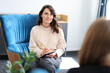 © Andrii Zastrozhnov - Young caucasian female therapist with notepad in counseling session