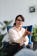 © Andrii Zastrozhnov - Young caucasian female therapist engaged in counseling session inside modern office