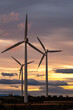 © yaqui_villegas - Renewable energy concept with wind turbines in Aragón, Spain, silhouetted against a vibrant sunset, representing sustainable energy and environmental harmony.