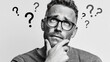 © FACTORY GRAPHICA  - Man Contemplating with Question Marks: A thoughtful man in glasses contemplates questions, surrounded by question marks. Capturing confusion and contemplation.