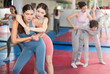 © JackF - Emotional woman trying to escape from back grip and delivering elbow strike to midsection to female opponent during mock bout in self-defense training