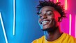 ©  Shomixer - A joyful young man with a bright smile, set against a backdrop of colorful neon lights, symbolizing positivity and the vibrancy of youth in modern life.