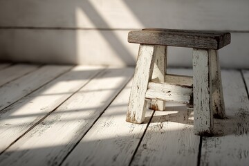 Poster - Small wooden stool placed on a rustic wooden floor with soft natural light casting shadows across the surface