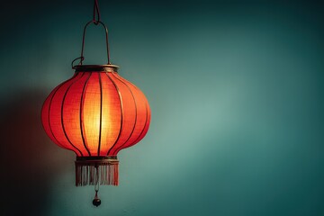 Poster - Bright red lantern illuminates a tranquil space with a soothing blue backdrop in a cozy setting
