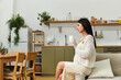© Bliss - Expecting mother enjoys a peaceful moment in a stylish kitchen while sipping tea