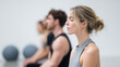 © DOUGLAS - Group of adults practicing Pilates meditation in bright studio, focusing on mindfulness and relaxation, with exercise balls in background, calm and peaceful atmosphere
