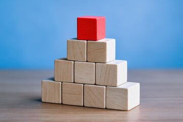 Poster - A wooden cube pyramid symbolizes strategic decision and growth in business with a single red block highlighting leadership innovation