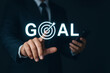 © Javelin - Businessman pointing at goal with arrow hitting the center of the target conceptual illustration