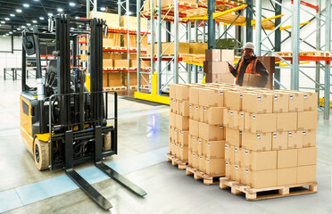 Poster - Man storekeeper. Customs officer near racks of boxes. Storekeeper with tablet keeps track of goods. Man standing in storage hangar. Customs warehouse. Storekeeper registers goods in application