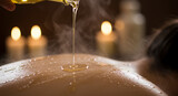 Warm oil being poured onto a wet back.