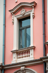 Poster - A bright pink building features a large clock on its exterior, perfect for use in illustrations about timekeeping, architecture, or whimsical scenes