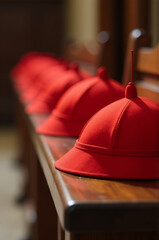 Poster - A row of red hats sitting on a wooden bench, ideal for use in photography, decoration or still life compositions