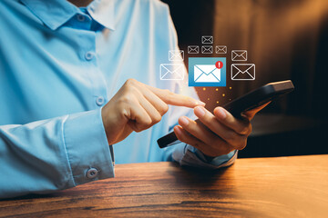 Poster - Email Notifications concept. Close-Up of Hand Using Smartphone with Email Notifications in Modern Workspace Setting