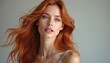 © Maryna - Beautiful young woman with coppery hair. Portrait of girl with red hair, delicate features, beautiful eyes, isolated. Girl looks directly at camera. Attractive appearance perfect for advertising