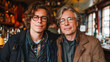 © Elena - Two men with glasses smiling together in a cozy bar setting with warm lighting and ambiance