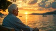 © Sah - Senior man sits contemplatively on a bench at sunset over the sea