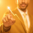 © Nathasa - Photography advertising shot of close up businessman touching an upward arrow on a virtual graph with empty background.