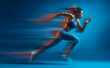 © A_visual - Motion blurred photo of female runner running in action pose with fast pace on bright blue gradient background. Commercial sports photography style.