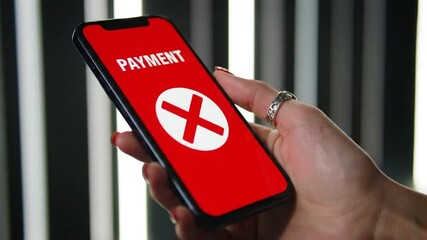 Poster - Hand Holding Smartphone With Red Payment Failure Screen On Striped Backdrop