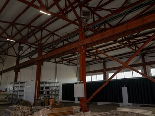 Poster - A large industrial building with a lot of empty space and a lot of metal