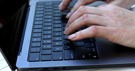 Poster - A person is typing on a laptop keyboard. Concept of productivity and focus, as the person is engaged in a task that requires concentration