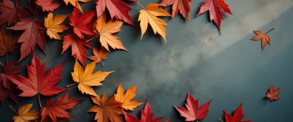 Poster - Colorful Autumn Maple Leaves on Textured Surface, Symbolizing Fall Season, Change, and Tranquility