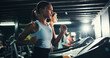 © peopleimages.com - Fitness, girl and running on treadmill in gym at night for agility training, endurance challenge or burning calories. Sweating, late exercise and runner with speed for intense cardio or race practice