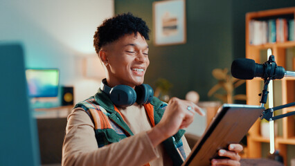Poster - Man, streamer and tablet in home with smile, mic and typing with script editing for video production. Gen z influencer, happy and app for chat, click and subscription list on social media at house