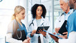 © peopleimages.com - Medical, report or tablet with doctors and nurses in hospital together for discussion or feedback. Conversation, healthcare and insurance with professional medicine team in clinic for collaboration