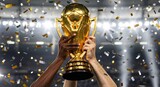 Hands holding a golden soccer trophy with confetti
