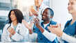 © peopleimages.com - Doctors, people and group with applause, meeting and support with goals, results and celebration. Men, women and team with smile for success, praise or achievement in career with cheers at hospital