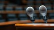 ©  zikakant - Two microphones positioned on a wooden podium indicate preparation for a public speaking event, representing communication, engagement, and the power of voice.