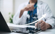 © Toowongsa - Doctor Using Digital Tablet for Healthcare Data Visualization