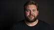 © Alteisen Riese - Plus size Caucasian man plain black background, looking proud