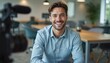 © miss irine - Young businessman smiles in office setting. Man in casual attire poses for camera. Professional, business, career, testimonial, review, leadership, communication, motivation. Workplace.