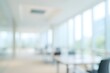 © Harris Kharisma - blurry image of office interior with bright, modern desk chairs and large windows
