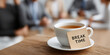© Amazight - A tea cup and saucer with a 'Break time' note on a wooden desk