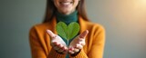 Smiling woman holding heart shape green leaf. ESG, eco friendly sustainable resources. Environmental ecology care concept. Symbol of green energy. Corporate social responsibility. Nature